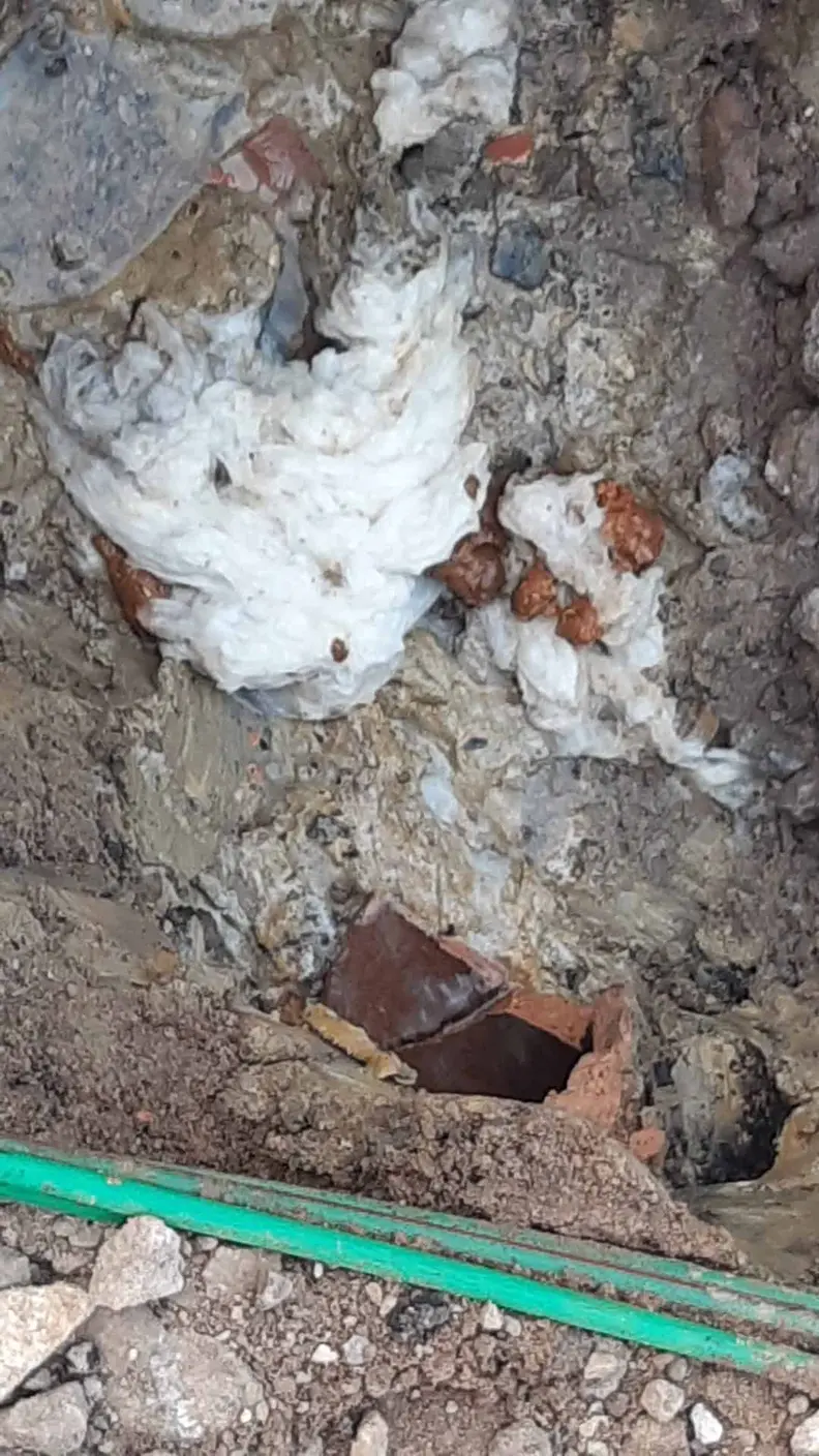 Broken clay drain pipe dug out at a house in Chaddesden, with debris packed into the ground around it