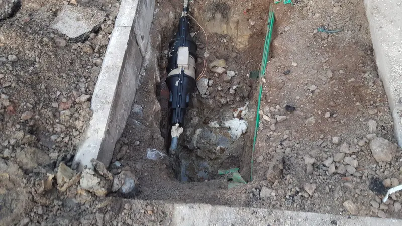 Black pipe coupling fitted into a drain run in an open trench, Allestree DE22